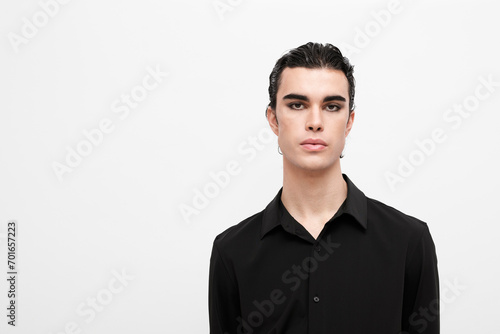 Young man wearing black shirt against white background photo