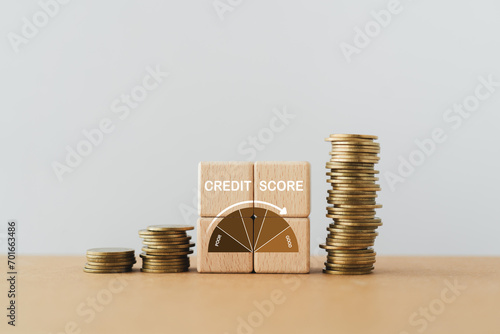 CREDIT SCORE text with indicator gauge meter on wooden cube block with stack of coins, copy space  included