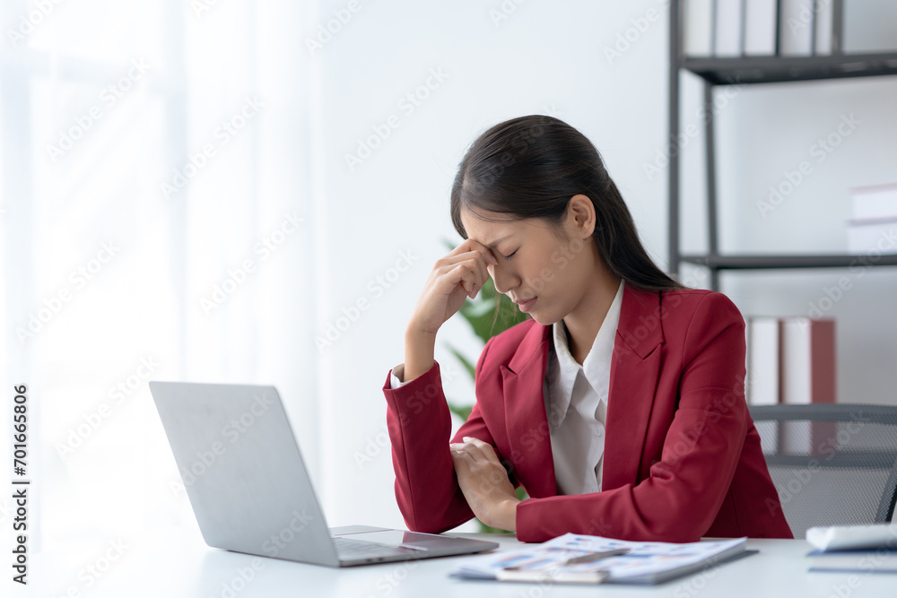 Stressed Asian Businesswoman Coping with Corporate Pressure at Office Desk. Workplace Burnout Concept. Stressed Asian Businesswoman Coping with Corporate Pressure at Office Desk. Workplace Burnout Concept.
