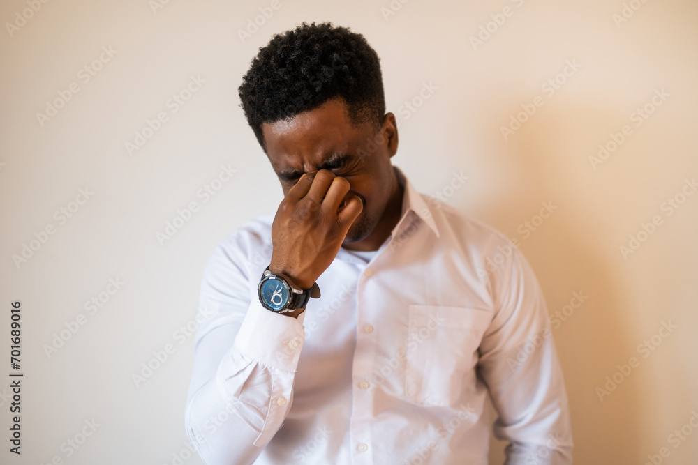 Portrait of young businessman who is tired and having headache. Portrait of young businessman who is tired and having headache.