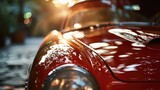 A close up view of a red car with the sun shining on it. Ideal for automotive enthusiasts or car-related content