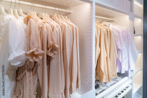 clothes hanging on rail in white wardrobe. © ake1150