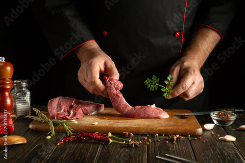 The chef is preparing aromatic lamb shish kebab on the kitchen table. The concept of cooking meat grill by the hands of a cook. Asian cuisine