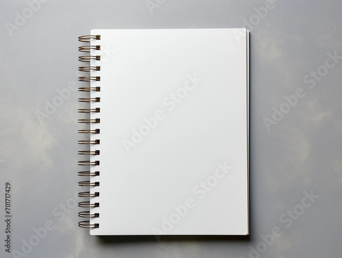 Blank spiral notebook over grey background flat lay 