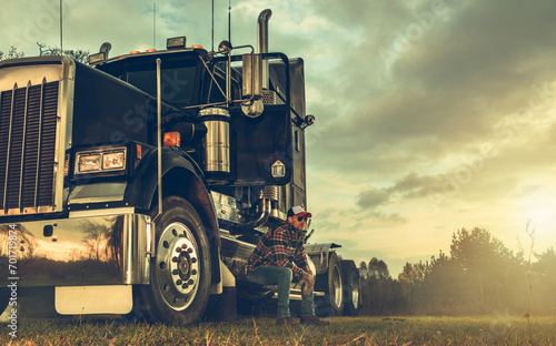 Professional Commercial CDL Truck Driver and His Semi Truck Tractor photo