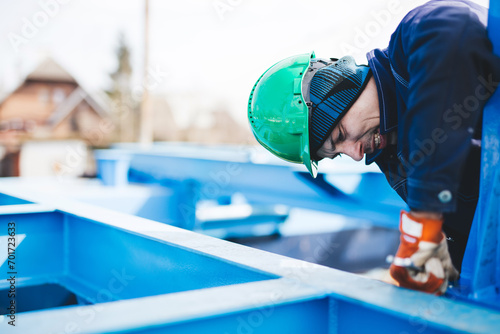 Manual worker working at shipyard construction site photo