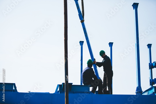 Manual workers working at shipyard construction site