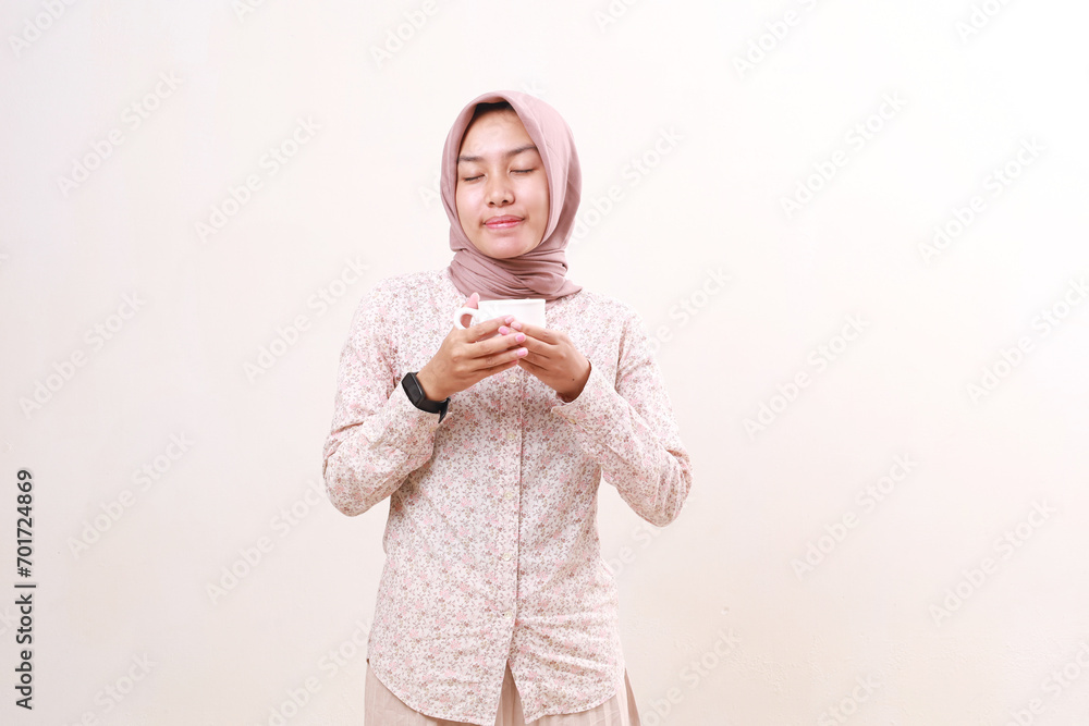 Young asian muslim woman inhale her drink. Isolated on white background Young asian muslim woman inhale her drink. Isolated on white background