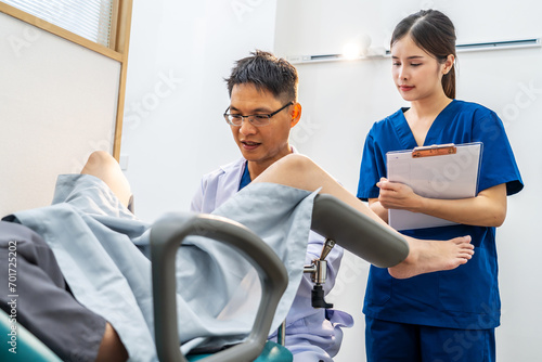 Male asian doctor doing internal examination on female patient at hospital room. They discussing about Illness with female patient at hospital  gynecological examination  conducting a pelvic exam