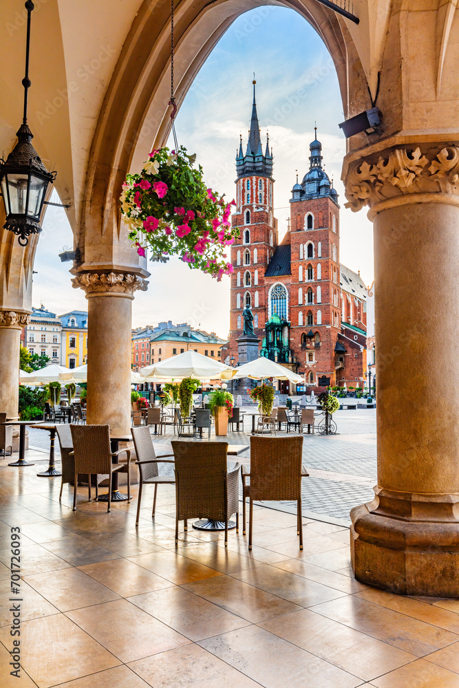 Obraz na płótnie Restaurant table and chairs on old town in Cracow, Poland. View from Cloth hall at sunrise w salonie