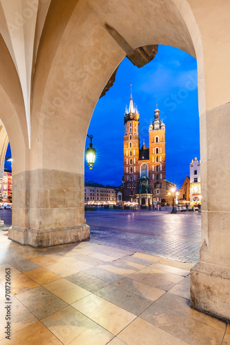 Cracow, Poland old town and St. Mary's Basilica seen from Cloth hall arch at night