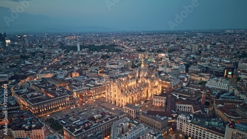 Aerial drone Milan cityscape featuring illuminated duomo di milano at dusk