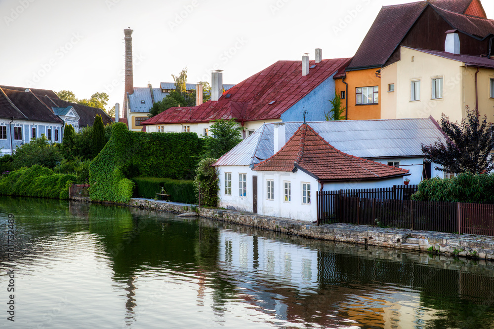 Fototapeta premium Houses Reflecting in the Vajgar Pond in the Hamersky Potok River at Jindrichuv Hradec in the Czech Republic