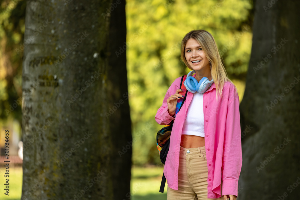 Blonde girl in pink jacket in the park Blonde girl in pink jacket in the park