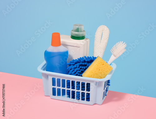 The blue basket with cleaning products. House cleaning concept.
