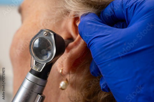 Otolaryngologist's office, examination of the girl's ear, ear plug, hearing test, doctor's examination photo