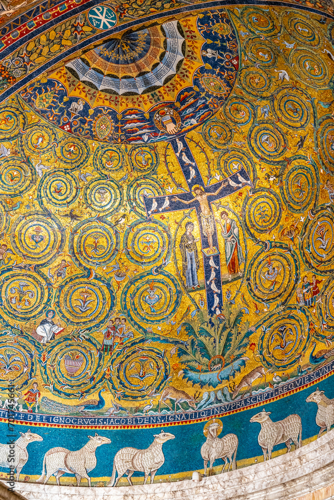 Detail of golden religious mosaic decorating the dome ceiling inside historic Basilica in Italy