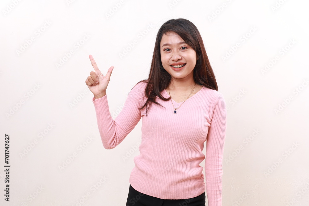 Wow excited amazed young asian girl standing while pointing sideways. Advertisement and promotional concept. Isolated on white background Wow excited amazed young asian girl standing while pointing sideways. Advertisement and promotional concept. Isolated on white background