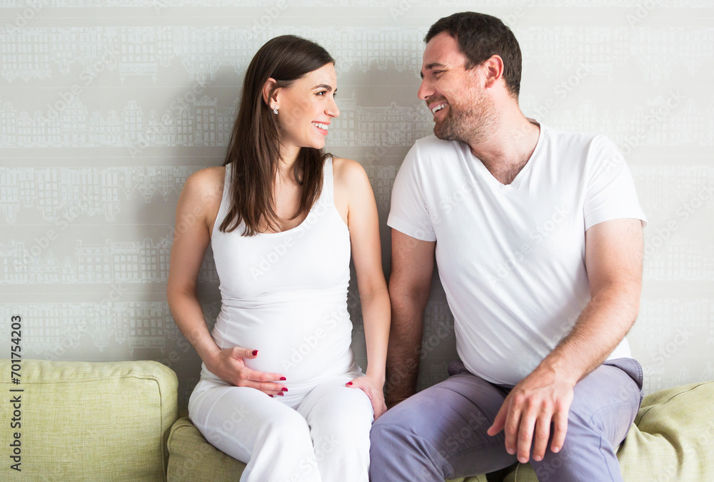 Pregnant woman and young man together indoors Pregnant woman and young man together indoors
