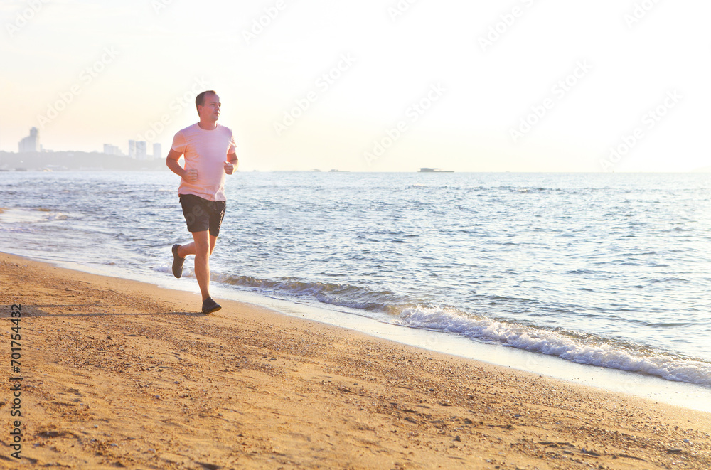 Man running on the beach at surise