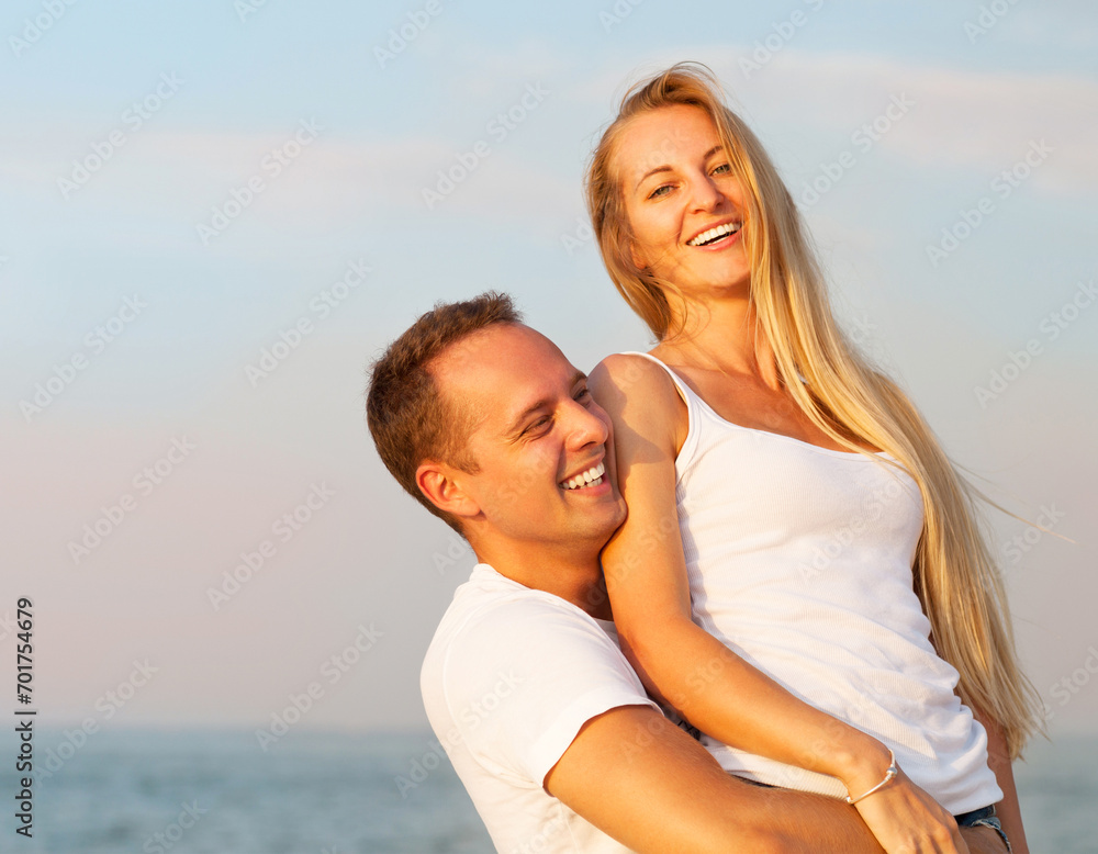 Laughing couple enjoying nature over sea background Laughing couple enjoying nature over sea background