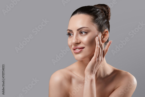 Beautiful Woman Face Skin Care. Portrait Of Attractive Young Female Applying Cream Cosmetics. Closeup Of Beauty Smiling Girl With Natural Makeup And Fresh Skin. Cosmetology. Dermatology. Spa.