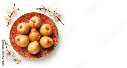 Group of pears on the plate chinese pattern style with flower props. Fresh ripe friut isolated on white background. Banner, wallpaper, cover, poster. Top view photo