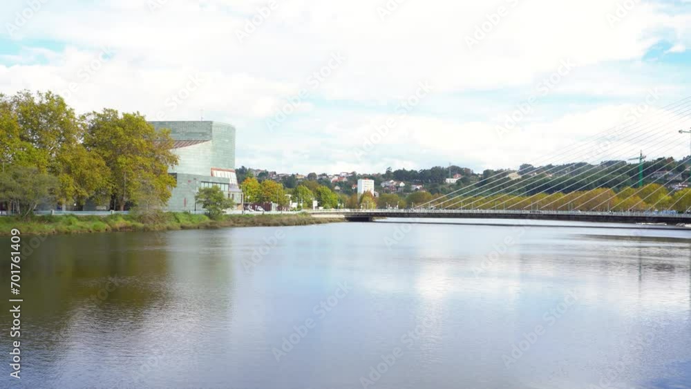 Pontevedra, Spain - October 26 2022: View of Puente de los Tirantes Bridge over Lerez River. Cars and peoples passing. Camera panning right. In background is Pontevedra city. Pontevedra, Spain - October 26 2022: View of Puente de los Tirantes Bridge over Lerez River. Cars and peoples passing. Camera panning right. In background is Pontevedra city.