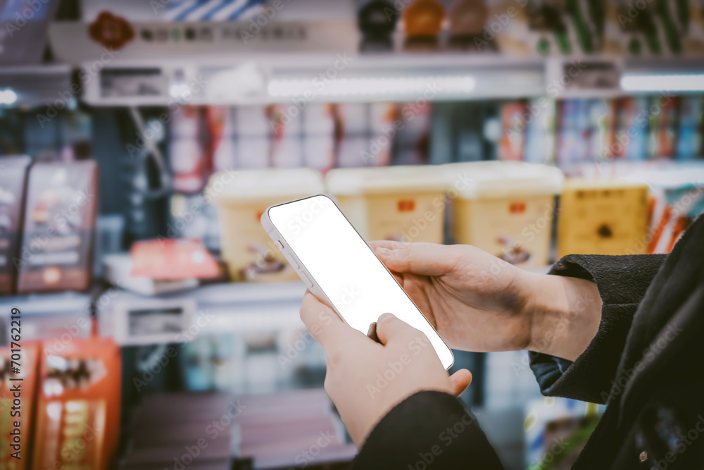Modern supermarket shopping consumers touch blank smartphones to make purchases.. Modern supermarket shopping consumers touch blank smartphones to make purchases..