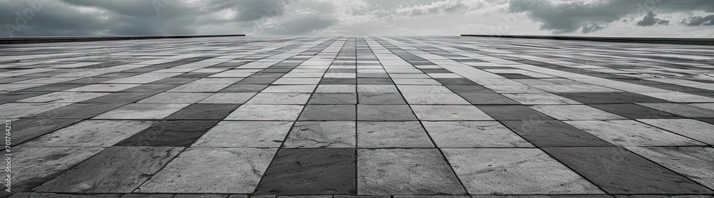 Detailed view of textured square pavement. Cobblestone charm. Vintage patterns on ancient urban path. Concrete symphony. Grey and black pavement in city