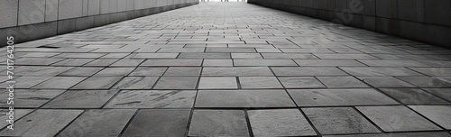 Detailed view of textured square pavement. Cobblestone charm. Vintage patterns on ancient urban path. Concrete symphony. Grey and black pavement in city