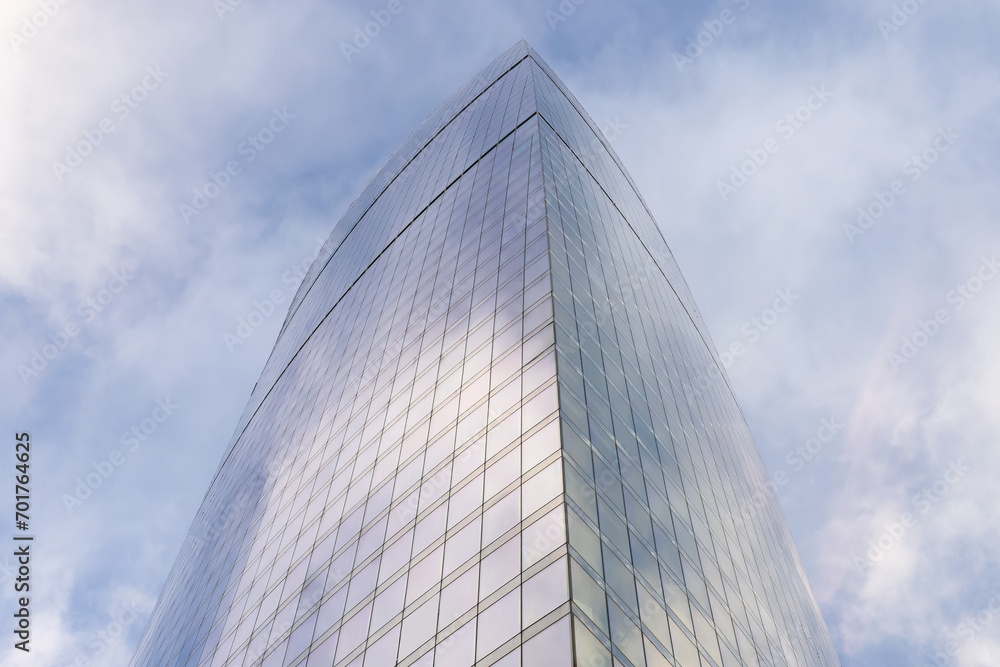 Modern skyscrapers in close-up with a wide angle against a background of blue sky with clouds in the business center of Moscow City. Modern skyscrapers in close-up with a wide angle against a background of blue sky with clouds in the business center of Moscow City.