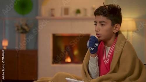 Young teenager sick kid suffering from cough and fever during winter season at home - concept of medical or healthcare problems and viral infection