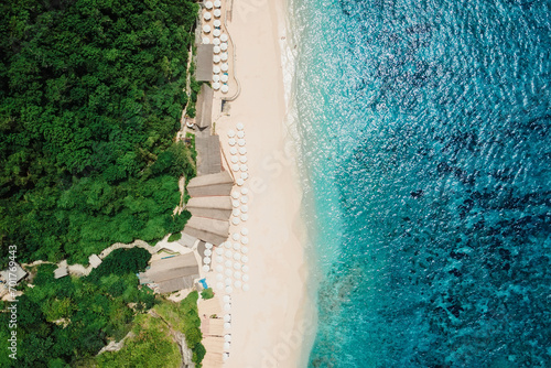 Paradise beach with turquoise ocean and resort in Bali. Aerial view