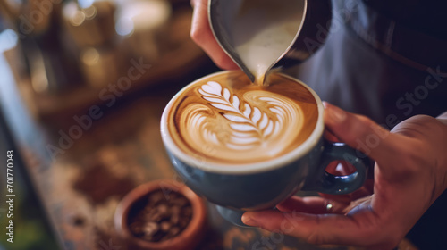 A barista carefully crafts latte art in a coffee cup, the foam forming a delicate pattern. photo