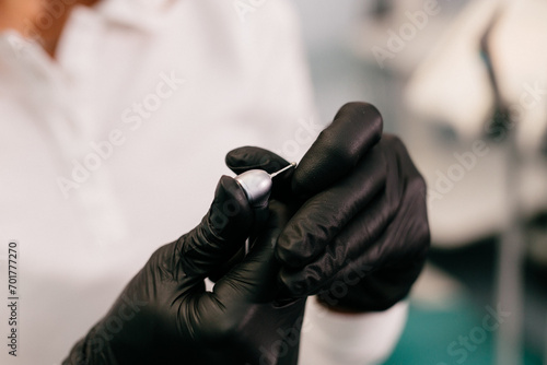 Young female dentist holds instruments in her hands in the interior of a modern dental clinic. The concept of professional activity  dental instruments and services.