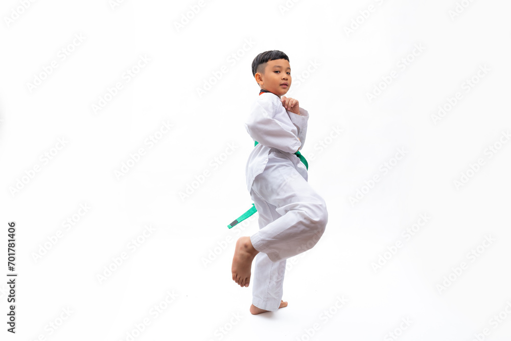 Practice Kick. kids karate martial arts. Taekwondo uniform with green belt. Portrait Thai Asian school boy isolated on white background banner. Action sport training concept Practice Kick. kids karate martial arts. Taekwondo uniform with green belt. Portrait Thai Asian school boy isolated on white background banner. Action sport training concept