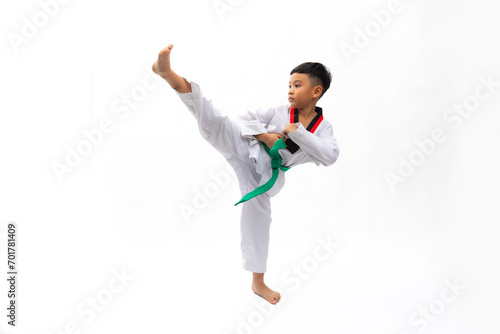 Practice side Kick. kids karate martial arts. Taekwondo uniform with green belt. Portrait Thai Asian school boy isolated on white background banner. Action sport training concept