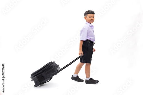 School children carrying school bags. Thai school uniform with backpack bag. Portrait Young Asian cute boy standing on white studio background banner. Back to school.