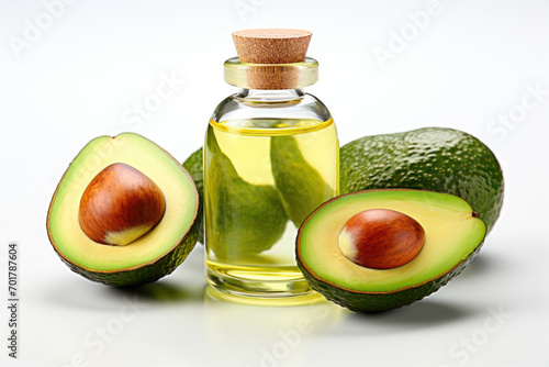 Cosmetic organic avocado oil in a glass jar and fresh in avocado on white background