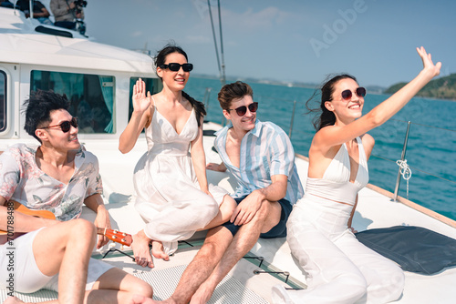 Happy carefree family travel adventures for young parents with daughter relaxing on luxury yacht at sunset, Sailing on catamaran having fun and good © chokniti