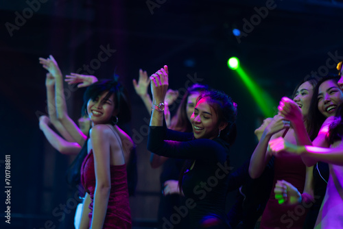 Nightlife and disco dance party concept. Sexy young woman people and friends dancing in night club. music festival. Cheerful Happy fun Asian people dance in night club