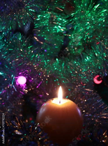 burning candle and christmas tree  photo