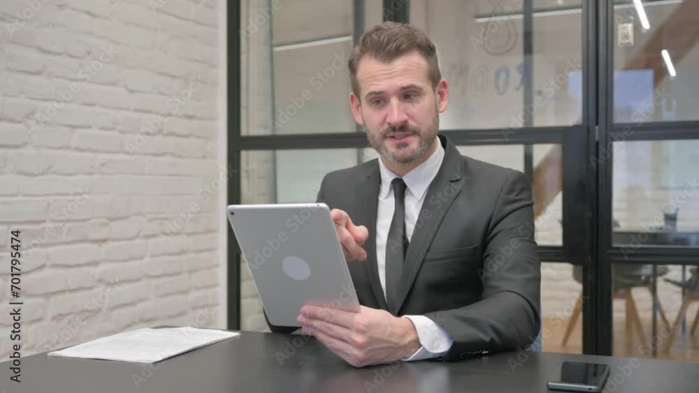 Middle Aged Businessman Doing Video Chat on Tablet Middle Aged Businessman Doing Video Chat on Tablet