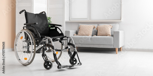 Modern empty wheelchair in living room photo