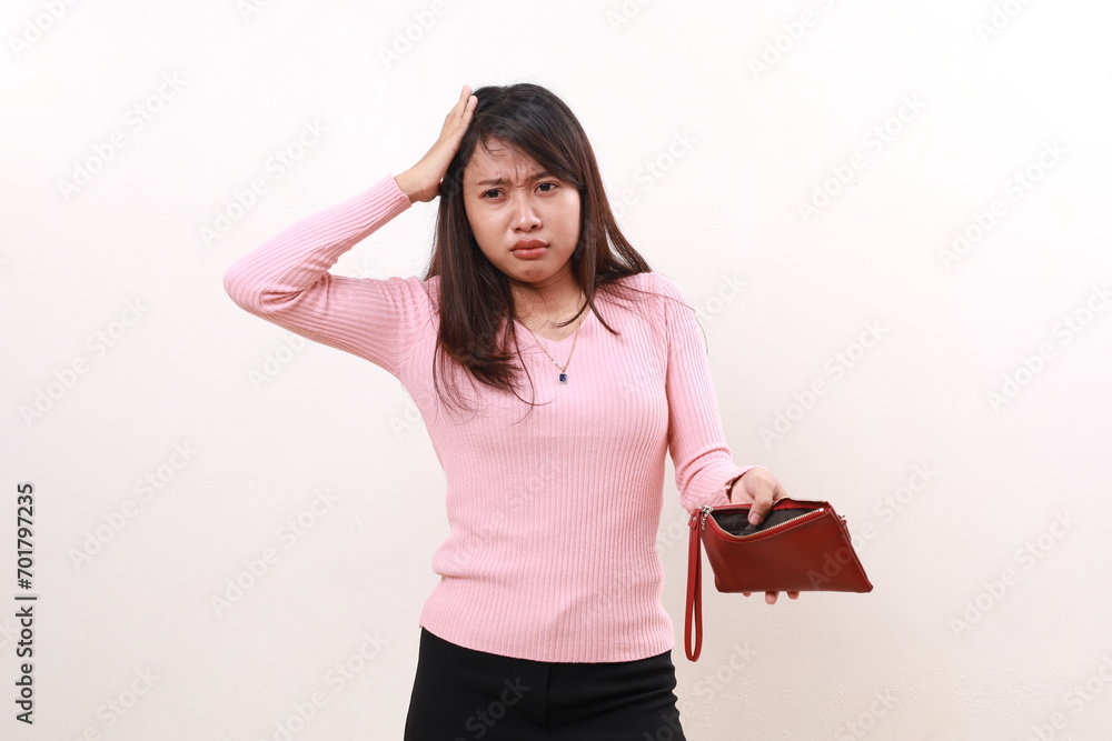 Sad unhappy frustrated young asian girl standing holding head while showing an empty wallet and looking sideways. Isolated on white background Sad unhappy frustrated young asian girl standing holding head while showing an empty wallet and looking sideways. Isolated on white background