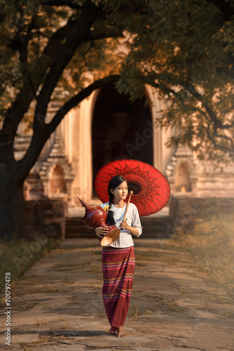 Portrait young Burmese girl posing with umbrella in Bagan