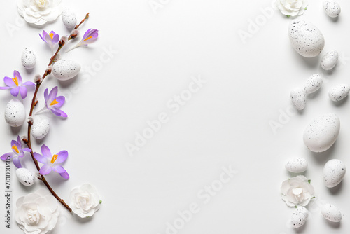 Composition with willow branch, Easter eggs and flowers on light background