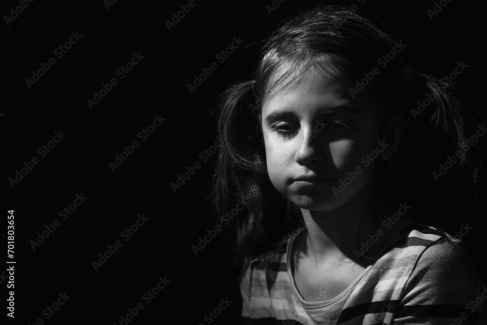 Portrait of crying young girl. Loneliness, depression, pain, child tragedy. Black and white image. Horizontal image. Copy space.