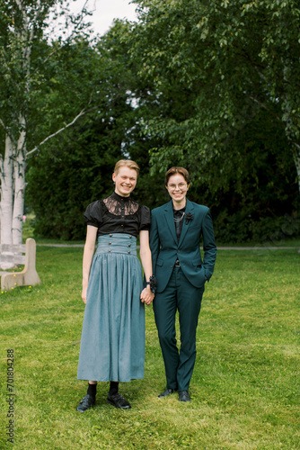 LGBTQ couple going to a high school prom together in a matching suit and dress.